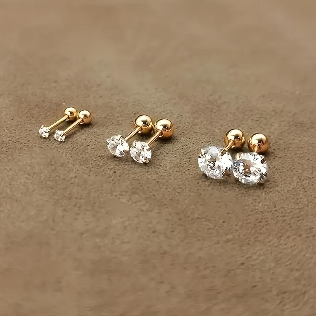 Golden four-prong twisted ball cubic Synthetic Zirconia earrings