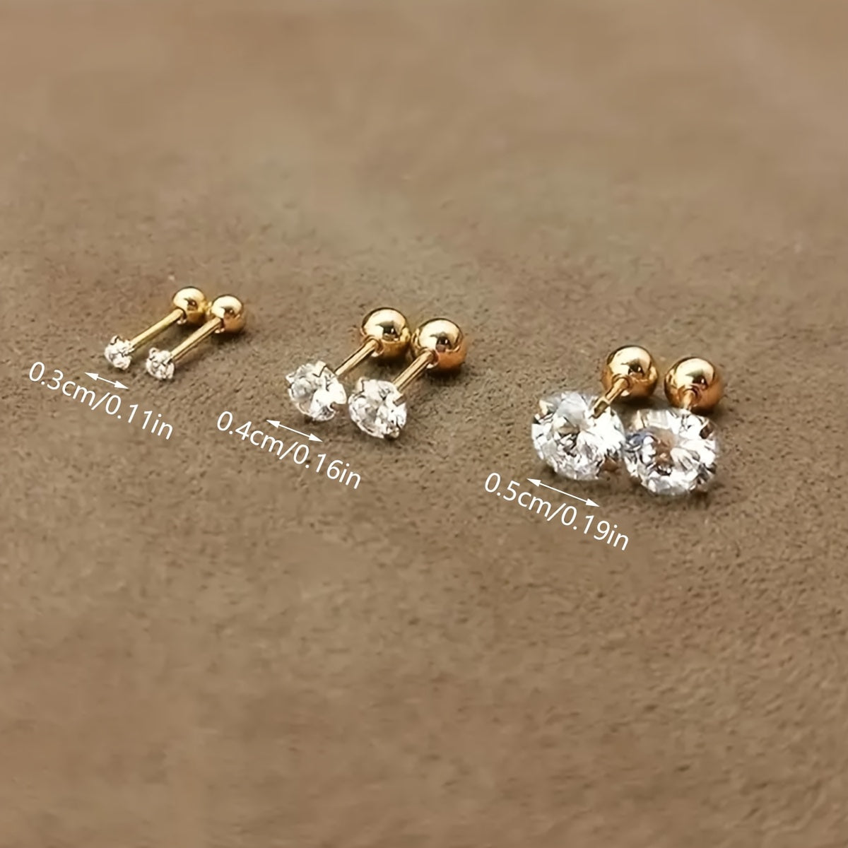 Golden four-prong twisted ball cubic Synthetic Zirconia earrings